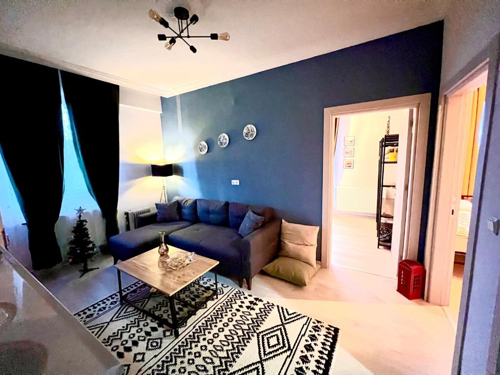 a living room with a blue couch and a table at Chic& cosy house with Kars Panorama in Kars