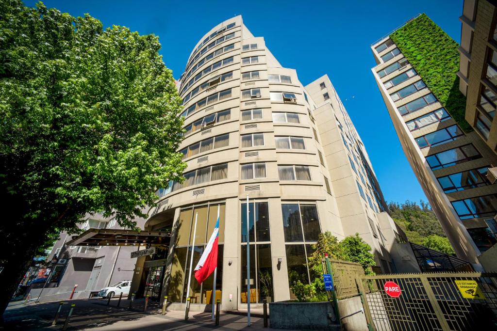 wysoki biały budynek z dwoma wysokimi budynkami w obiekcie Hotel Diego de Almagro Concepción w mieście Concepción