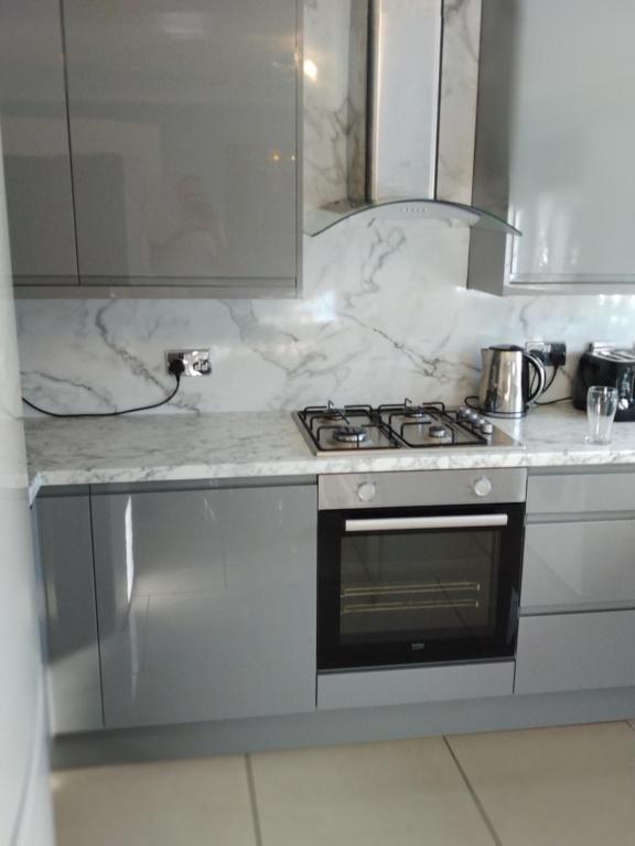 a kitchen with a stove and a counter top at Riverside in Liverpool