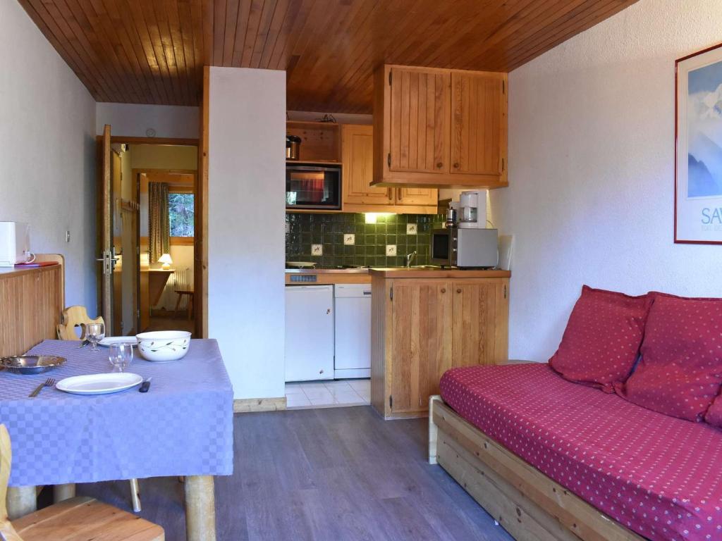 Cette chambre dispose d'un canapé, d'une table et d'une cuisine. dans l'établissement Charmant appartement à Méribel, 4 pers, proche pistes et commerces - FR-1-180-74, à Les Allues