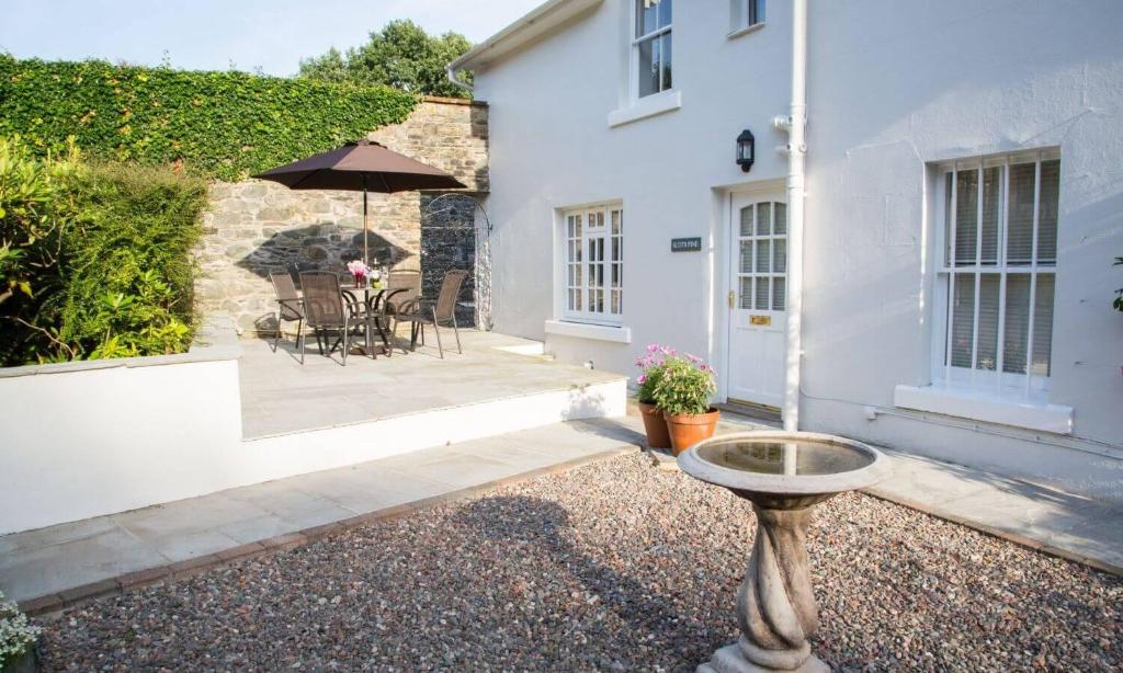 a house with a bird bath in front of it at Scots Pine in Keswick