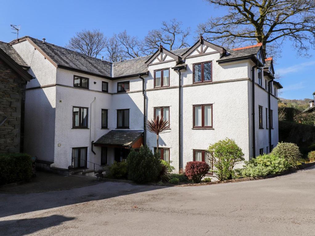 a large white house with a driveway at Ambleside Haven in Ambleside