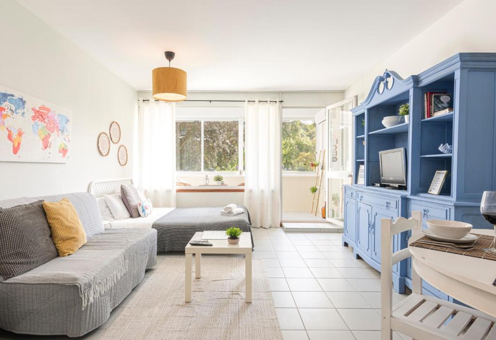 a living room with blue cabinets and a couch at GOLD - Vilamoura in Vilamoura