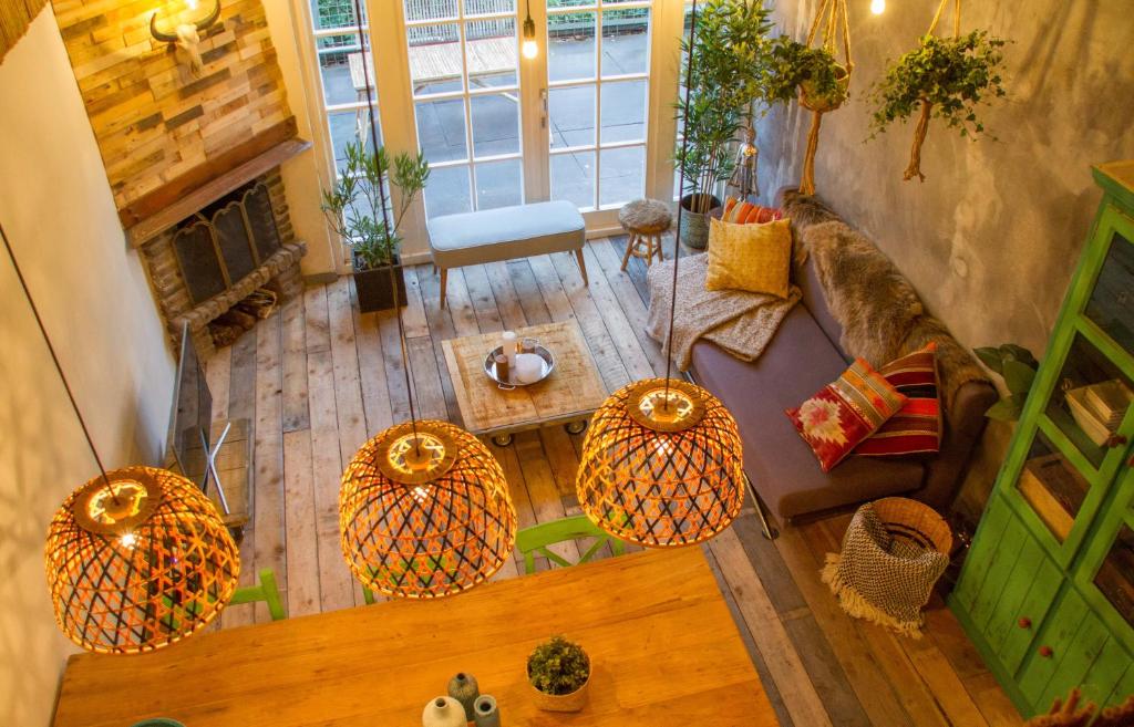 an overhead view of a living room with a couch and a table at Balistyle guesthouse in the forest near Amsterdam in Velsen-Zuid