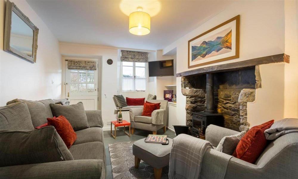 a living room with a couch and a fireplace at Lettera in Ambleside