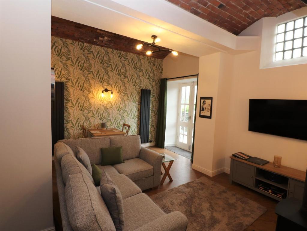 a living room with a couch and a tv at Fair Cop in Hawkshead