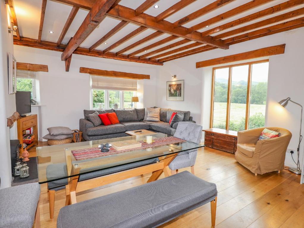 a living room with a couch and a table at Glen View Cottage in Ambleside