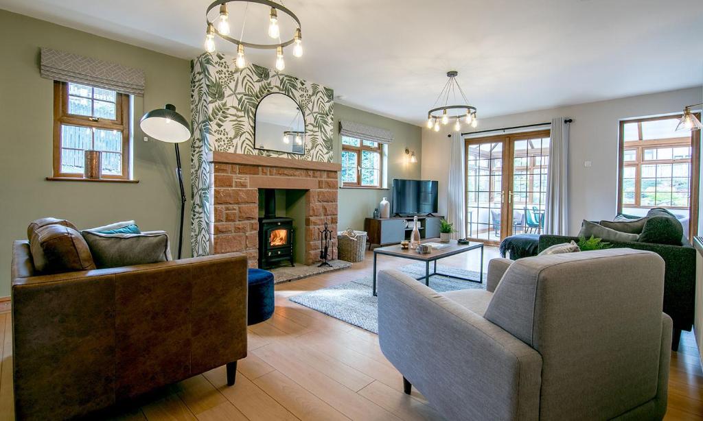 a living room with a couch and a fireplace at Simcas House in Stainton