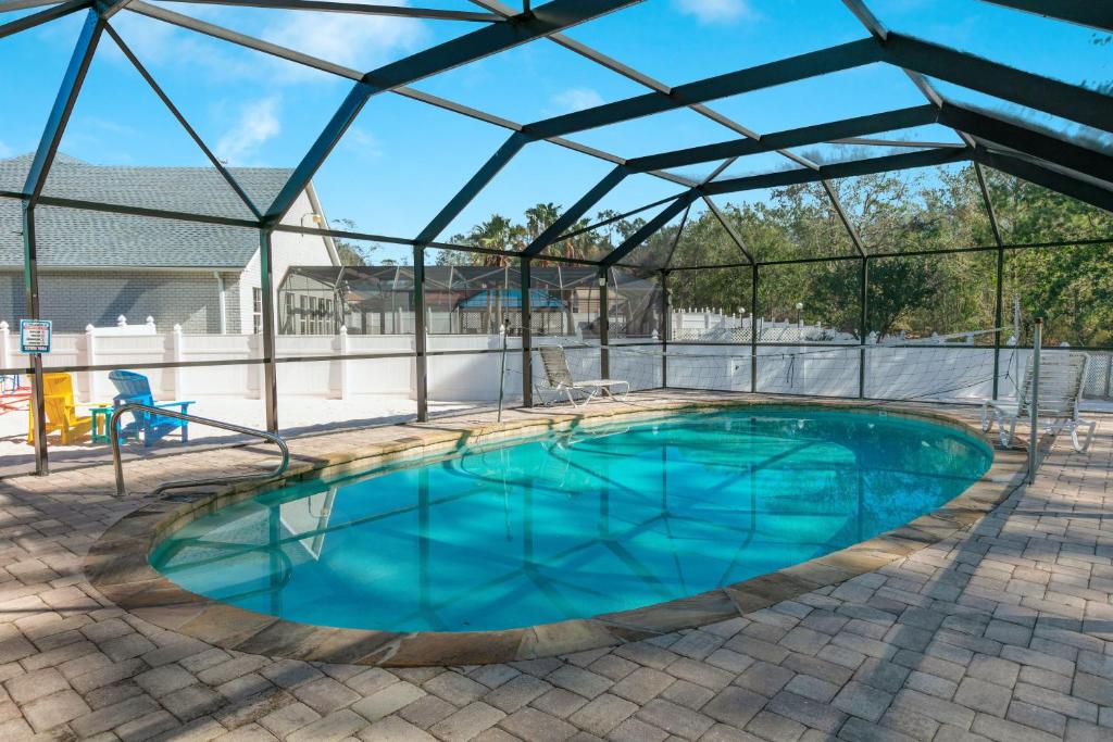 a large swimming pool with a glass roof at Happy Ours in Foley