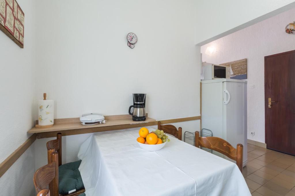 a kitchen with a table with a bowl of fruit on it at Apartments with a parking space Karigador, Novigrad - 2534 in Karigador