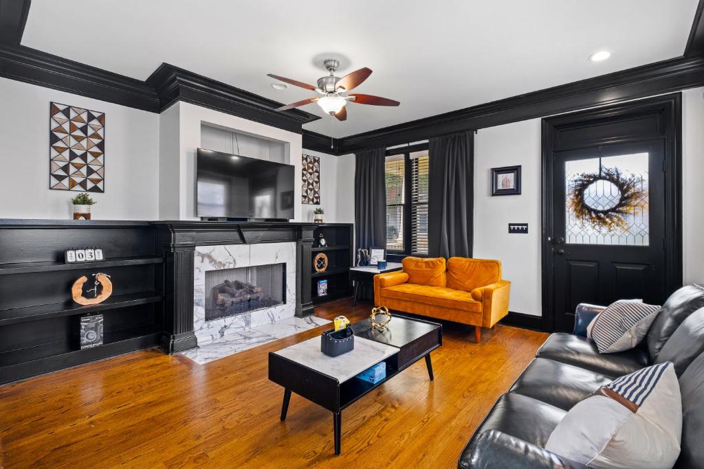 a living room with a couch and a fireplace at Vine City Bee Hive in Atlanta