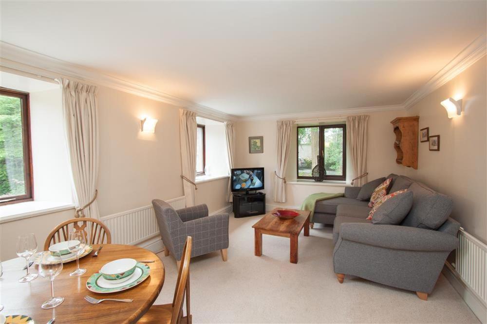a living room with a couch and a table at Over Ghyll in Ambleside