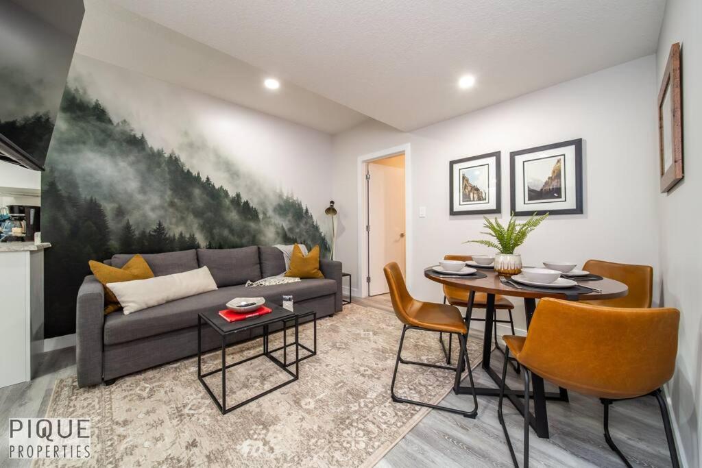 a living room with a couch and a table at NEW, Mountain Chic Suite, Whyte Avenue, Netflix, WiFi, Sleeps 6 in Edmonton