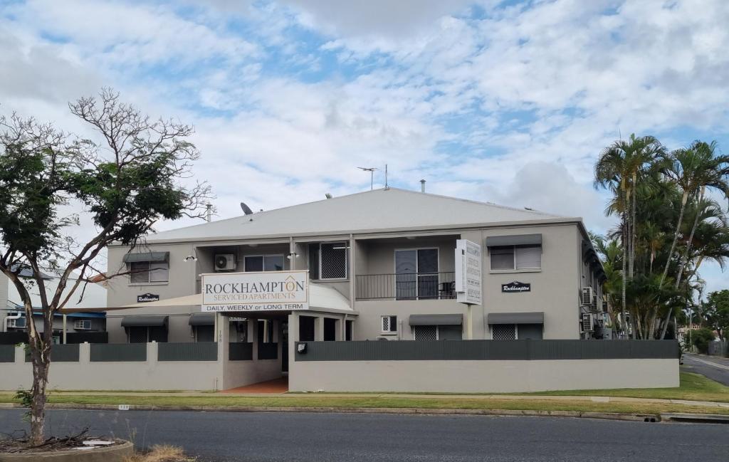 a white building with a sign on it at Rockhampton Serviced Apartments in Rockhampton