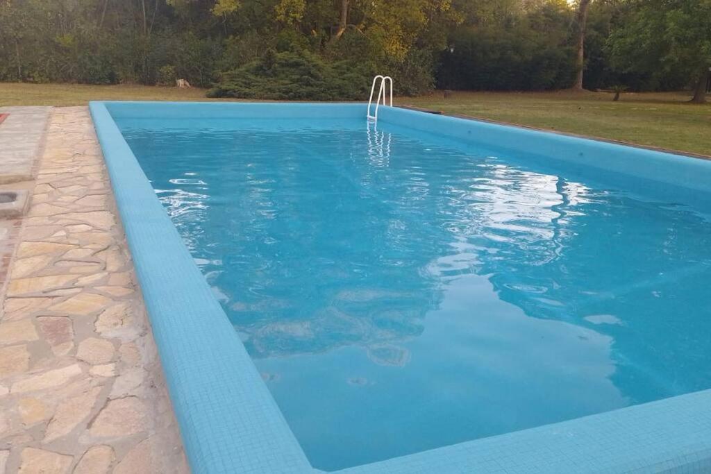 a swimming pool with a blue swimming pool at Quinta con pileta in Diego Gaynor