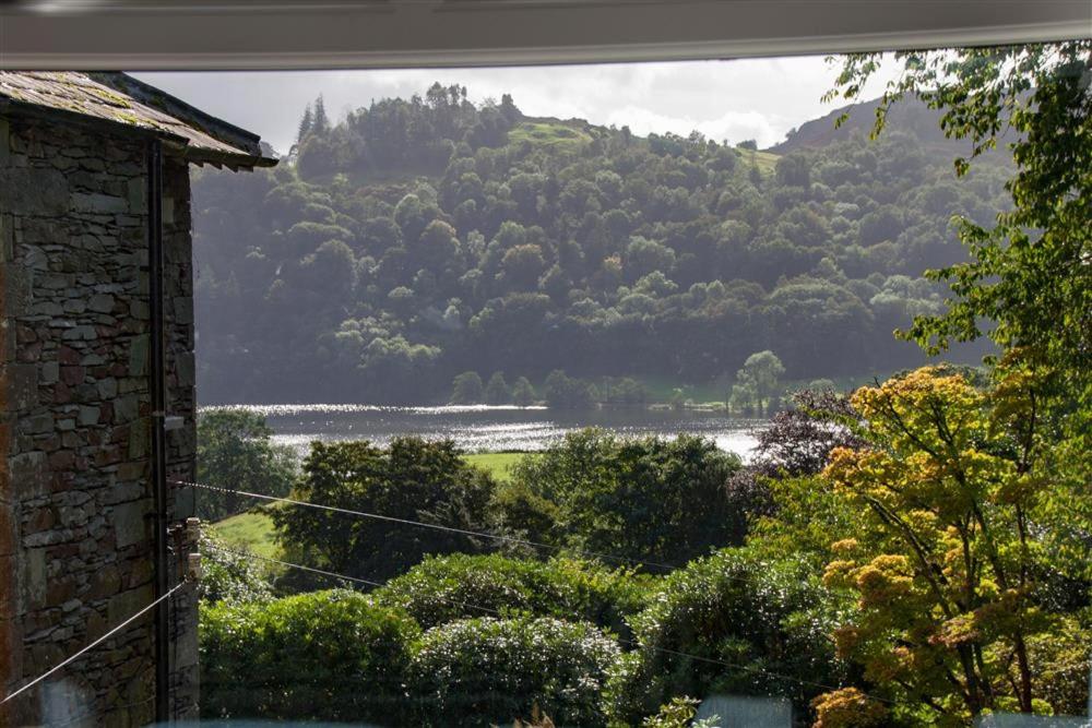 a view of a mountain and a lake from a house at Helm Crag in Grasmere