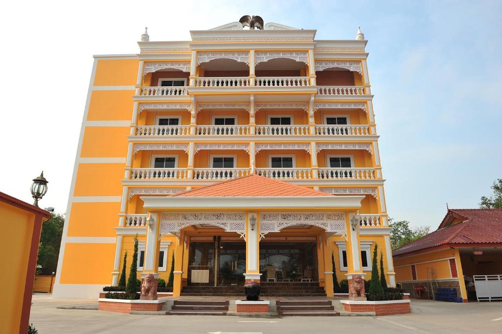 a large orange building with a balcony at โรงแรมกู๊ดเรสซิเดนซ์ - Good Residence in Nong Khae