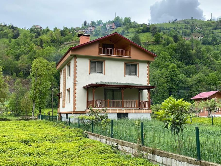 a house on a hill with a fence at Zeni Villa - Fırtına Deresinde mükemmel konaklama in Rize