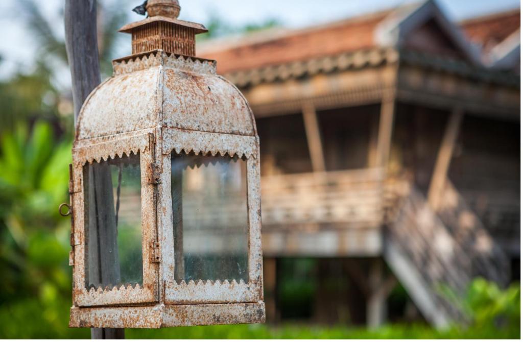 an old light in front of a house at Sala Lodges in Siem Reap