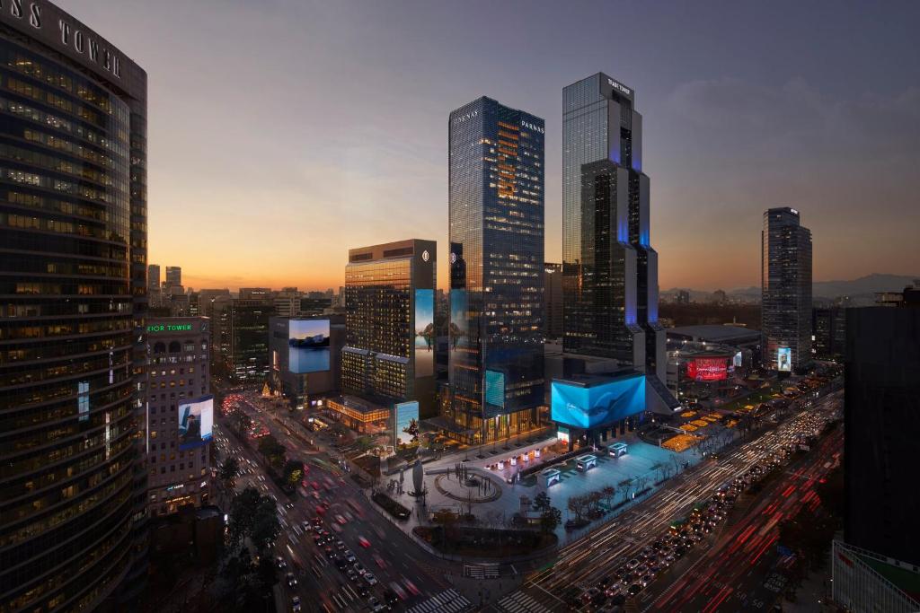 a city skyline with tall buildings and traffic in a city at Grand InterContinental Seoul Parnas, an IHG Hotel in Seoul