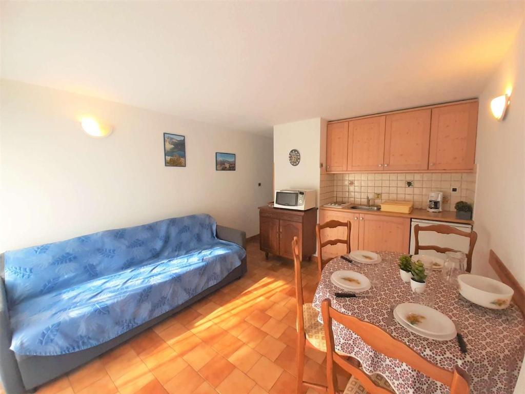 un salon avec un canapé et une table et une cuisine dans l'établissement Appartement T2 à Saint-Lary pour 6 personnes avec balcon, exposition sud, parking et casier à skis - FR-1-457-189, à Saint-Lary-Soulan