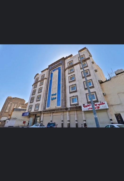 a building with a blue sign on the side of it at ريتاج الفضية للوحدات السكنية in Medina