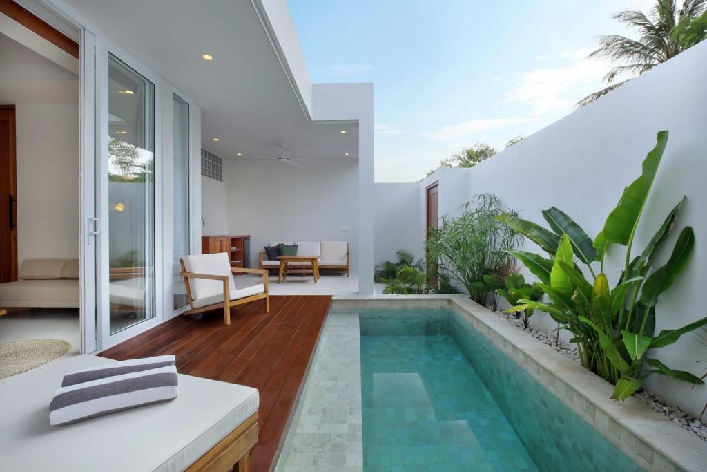 a swimming pool in the middle of a house at Neptune Studios Lombok in Kuta Lombok