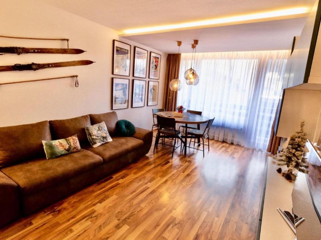 a living room with a couch and a table at Apartment in thermal and winter sports resort of Bad Gastein in Bad Gastein