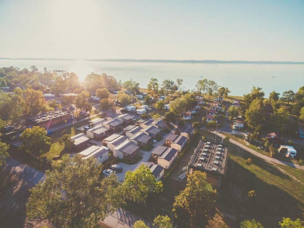 an aerial view of a parking lot next to the water at Aranypart Camping in Siófok