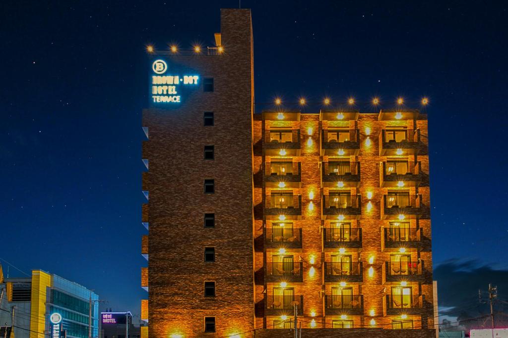 a tall building with lights on it at night at Browndot Terrace Pohang Passenger Terminal in Pohang