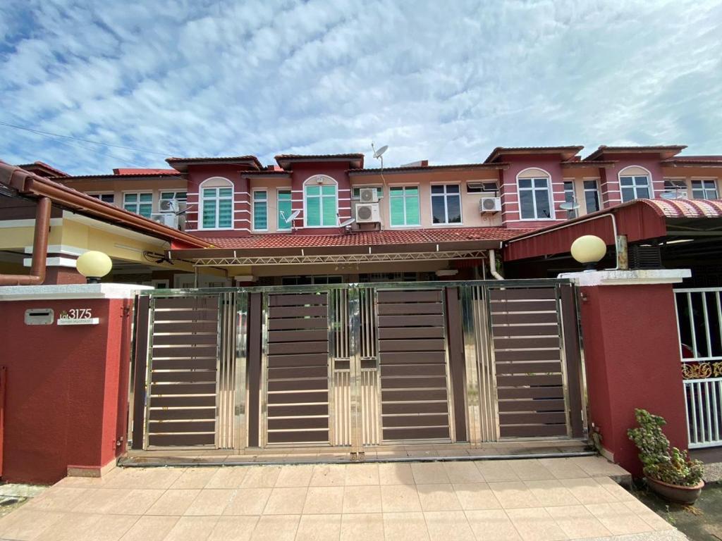 a house with a gate in front of it at Homestay LA Kota Bharu in Kota Bharu