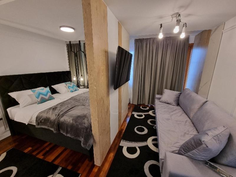 a living room with a bed and a couch at Apartman Vučko 118 in Jahorina