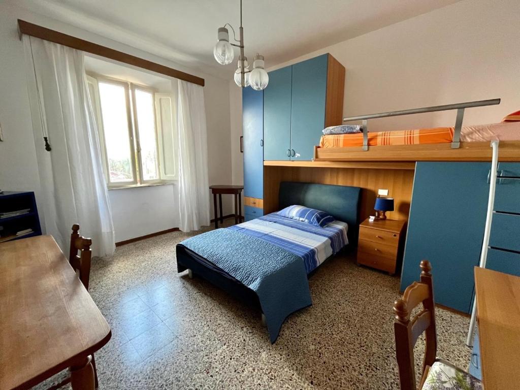 a bedroom with a bed with a blue wall at Casa Graziella in Cecina