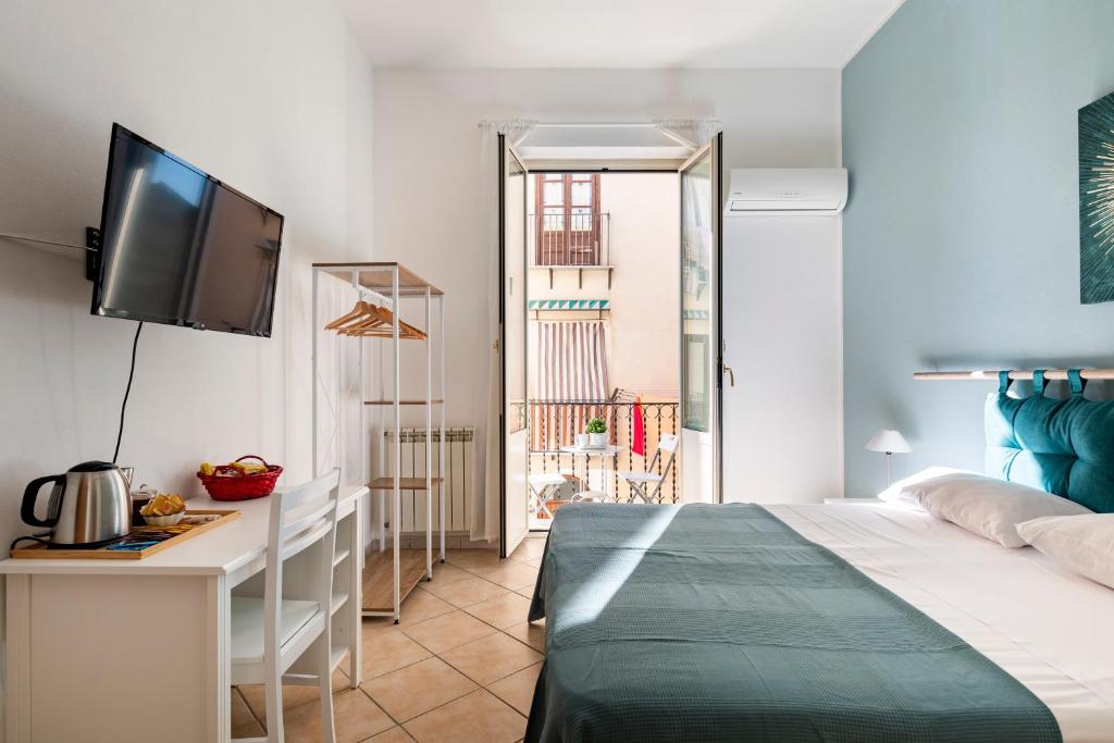 מיטה או מיטות בחדר ב-Punto al Capo Appartamento intero o stanze matrimoniali con bagno privato