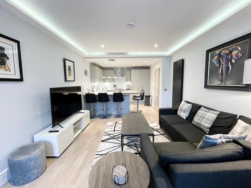 a living room with a couch and a table at Modern 3 Bedroom Apartment, West End in Edinburgh