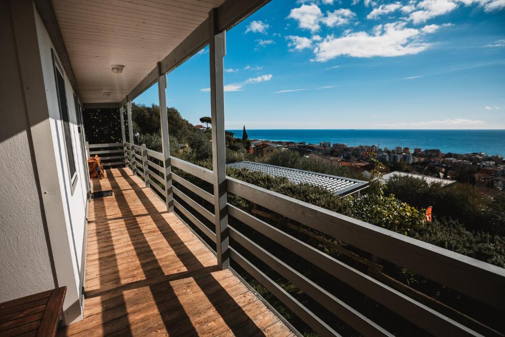 a balcony of a house with a view of the ocean at Agriturismo Rose di Pietra in Pietra Ligure