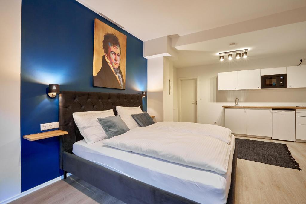 a bedroom with a large bed and a blue wall at Humboldt41 in Nuremberg