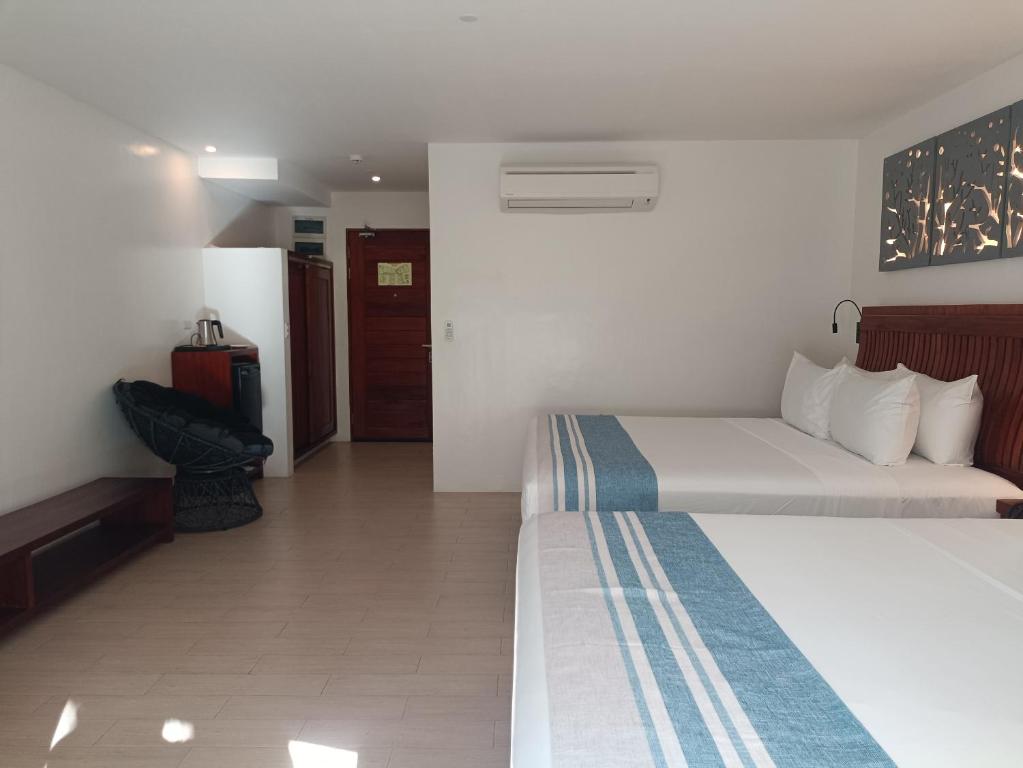 Postel nebo postele na pokoji v ubytování Aira Boracay Hotel