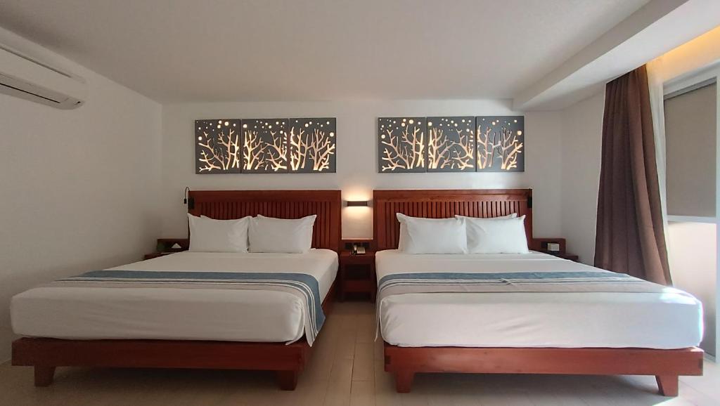 Postel nebo postele na pokoji v ubytování Aira Boracay Hotel