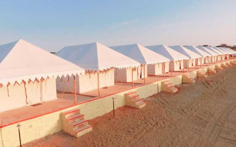 a row of white tents on a beach at Thar Royal Desert Camp in Sām
