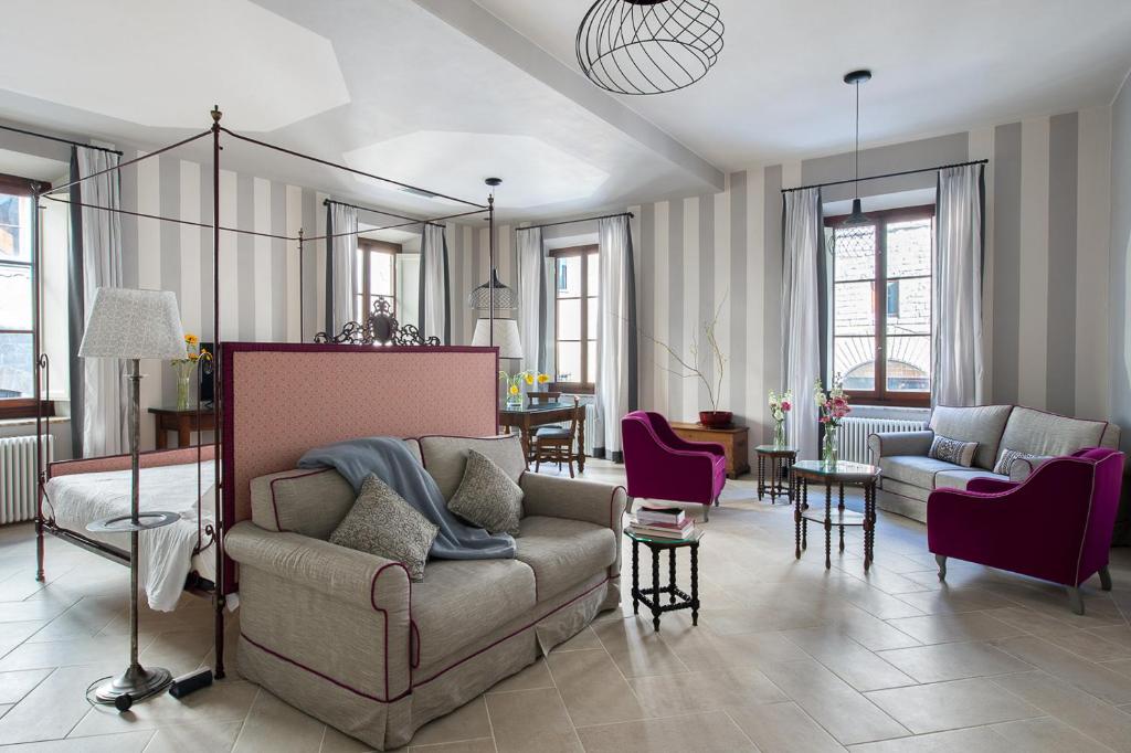 a living room with a couch and chairs at BorgoDeGreci Apartments in Florence