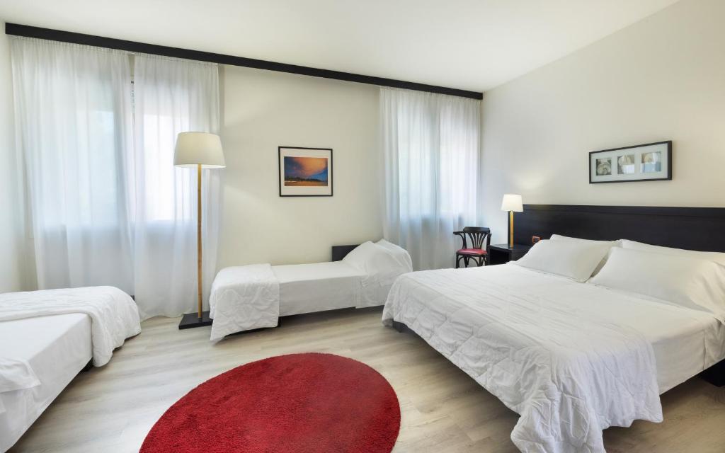 Posteľ alebo postele v izbe v ubytovaní Hotel Mosaico