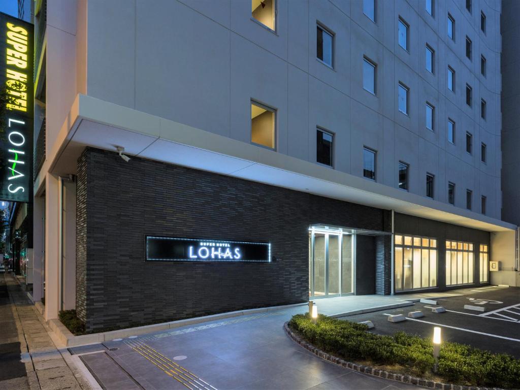 a building with a sign on the side of it at Super Hotel Premier Hakataeki in Fukuoka