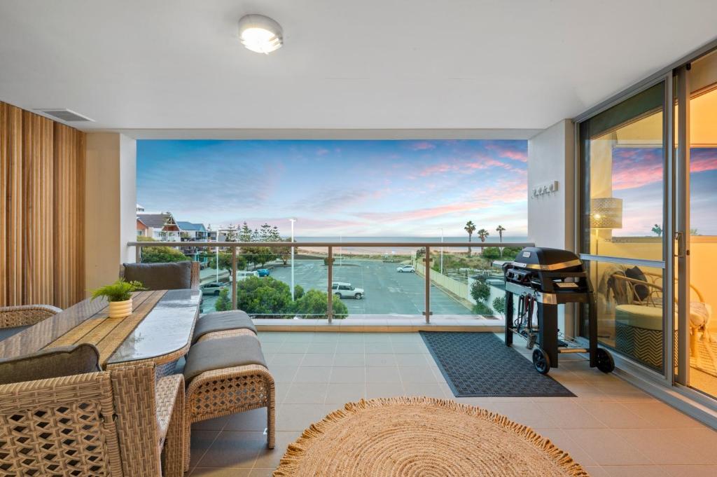 a living room with a balcony with a view at Suite 3201 Three Bedroom Luxe Oceanview Apartment in Mandurah