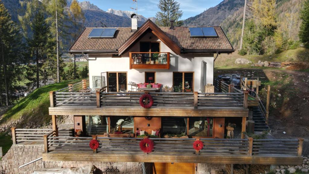 a house with solar panels on top of it at Villa Bosca - Adults Only in Predazzo
