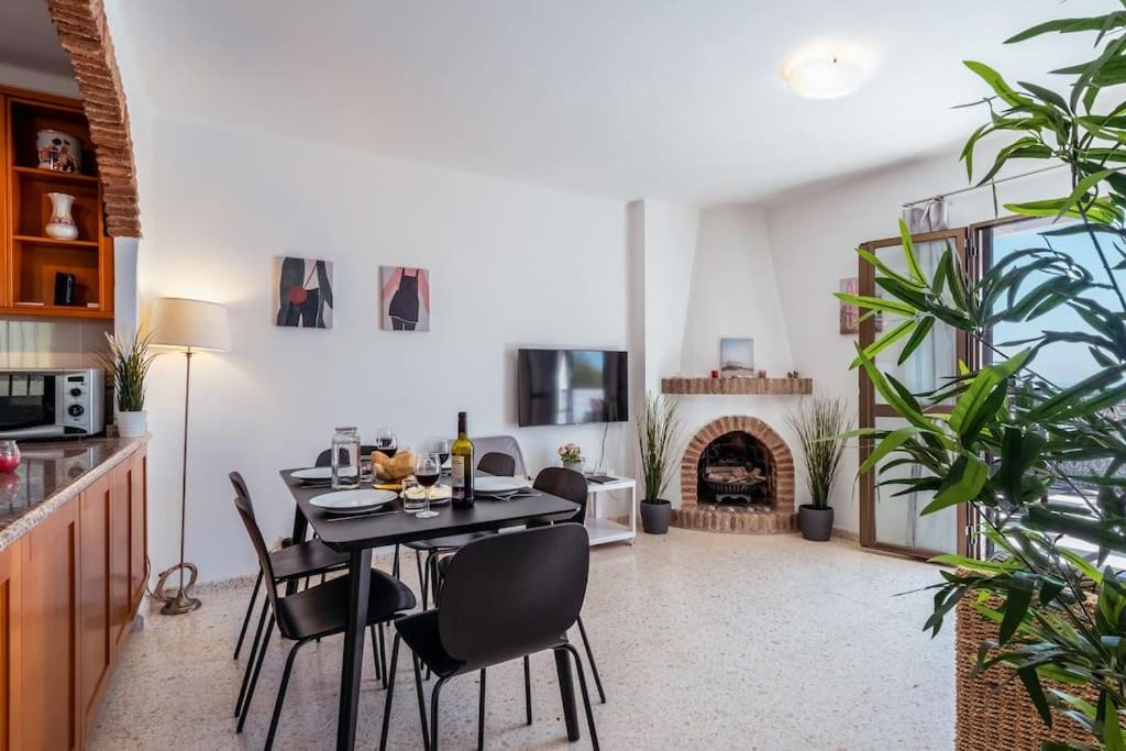a dining room with a table and a fireplace at Oasis 16 in Nerja