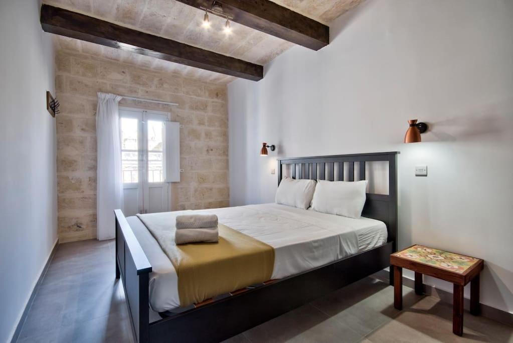 a bedroom with a large bed in a room at Old Lodge Apartment 7 by Vallettastay in Valletta