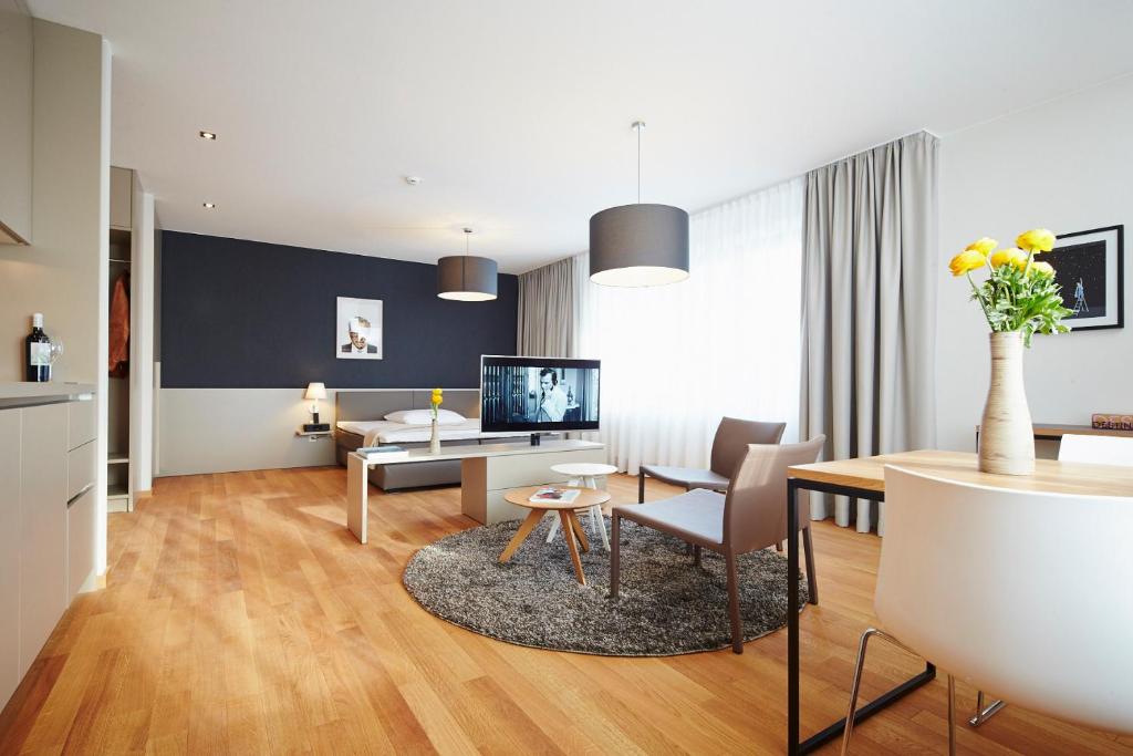 a living room with a table and a dining room at ipartment Frankfurt City Centre in Frankfurt/Main
