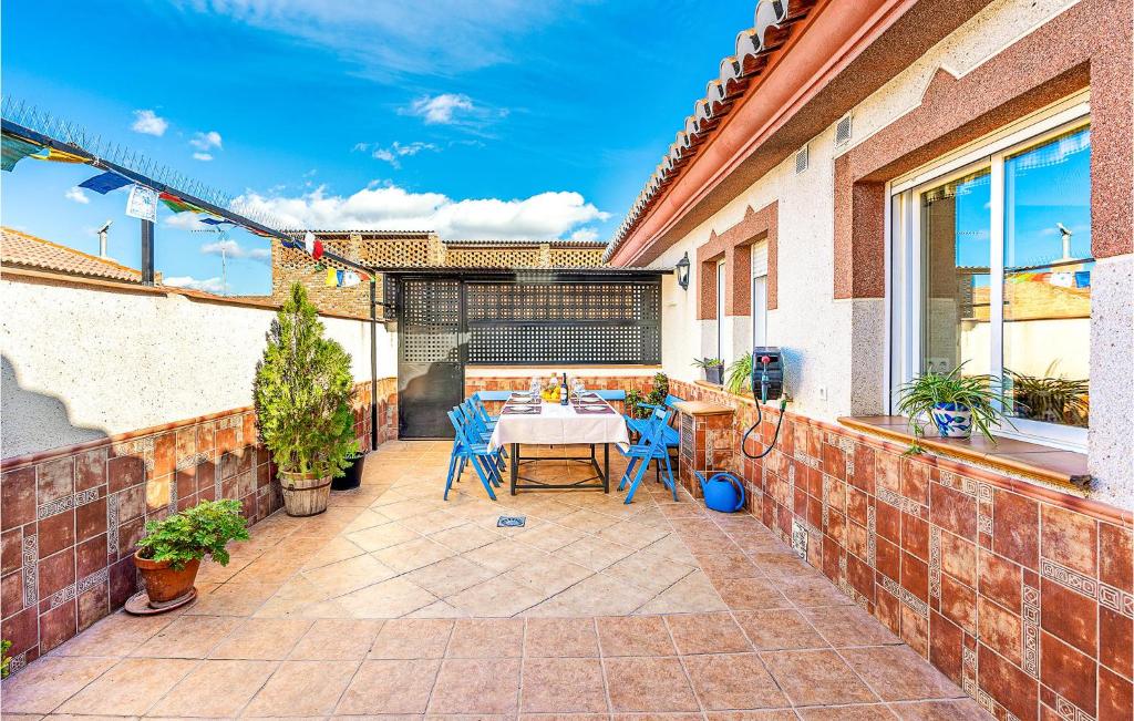 a patio with a table and chairs in a house at Stunning Air Conditioned House in Cijuela