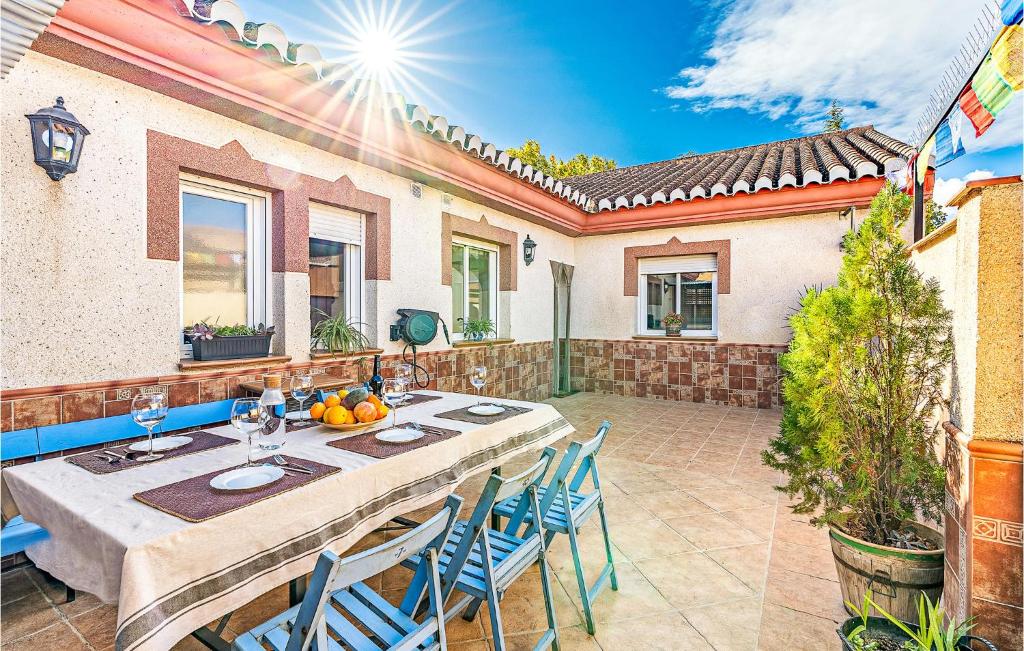 een patio met een tafel en stoelen en een huis bij Stunning Air Conditioned House in Cijuela